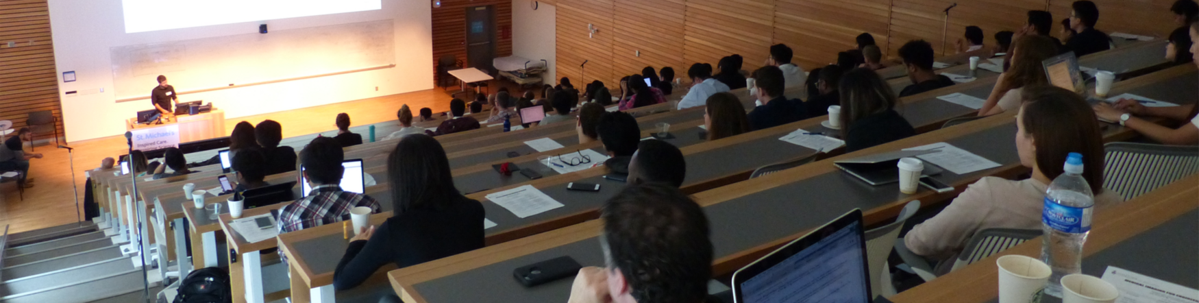 Photograph of a lecture room with presenter and audience