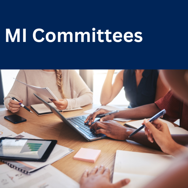 stock photo of people at a table working with "MI Committees"